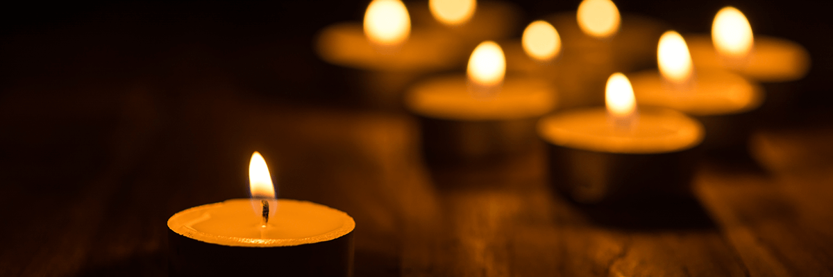 Lit candles float along surface of water