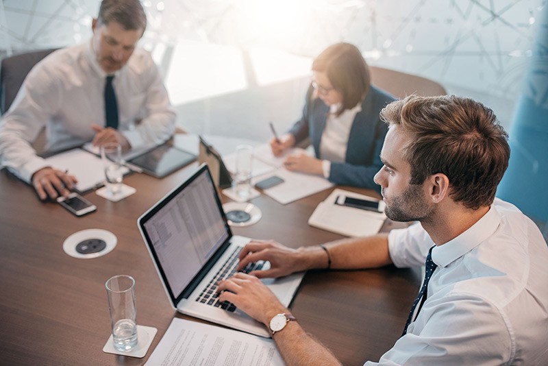 Business man in conference room with his laptop