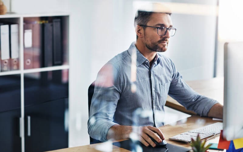 man-using-monitor-screen-at-desk