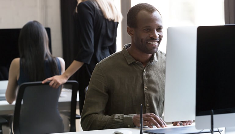 Businessman using VMware software on desktop computer