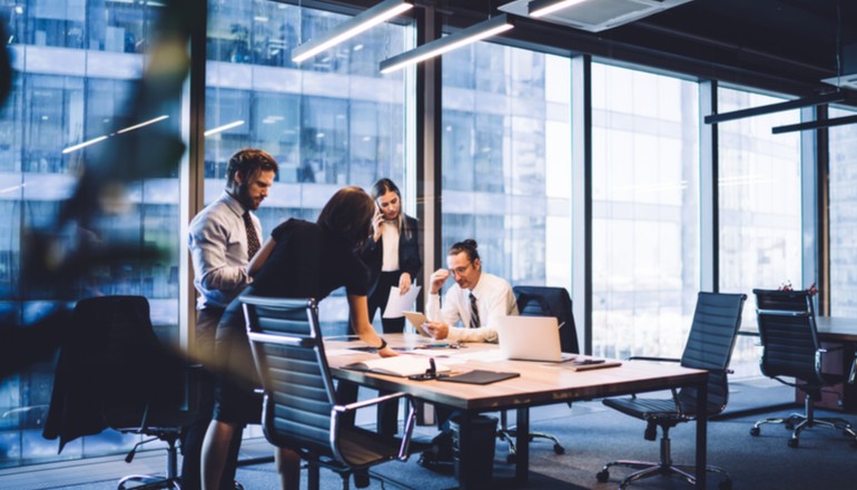 Users in meeting room going over finance