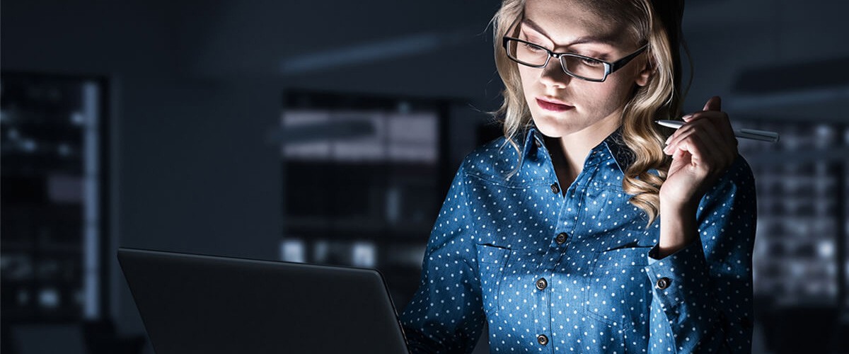 Business woman reviews personal data on laptop computer