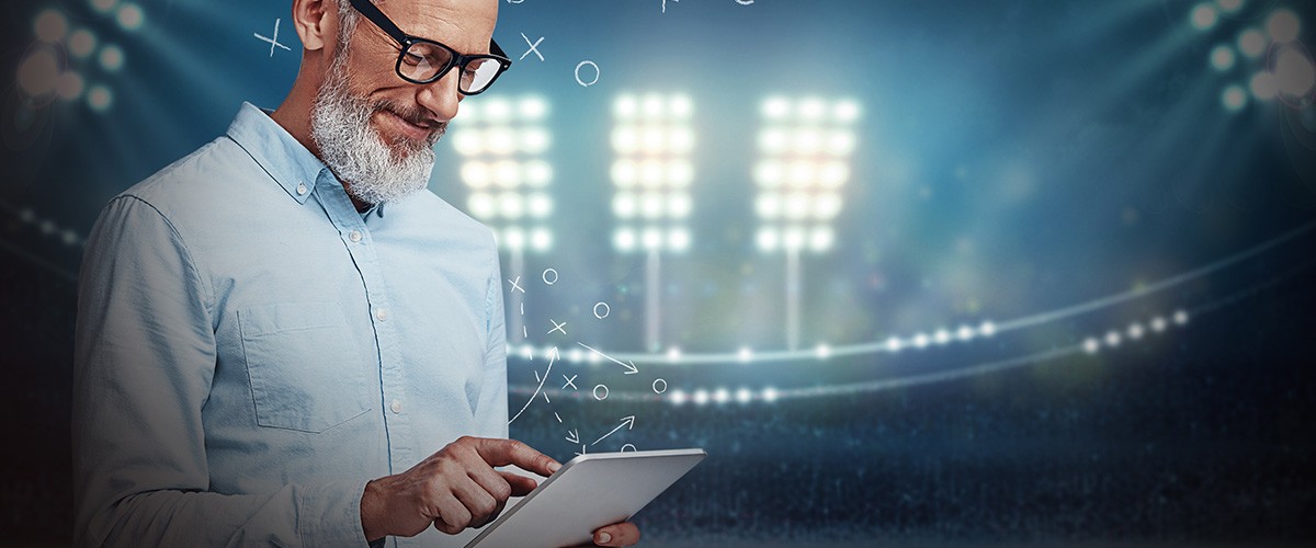 Man holding ipad in stadium