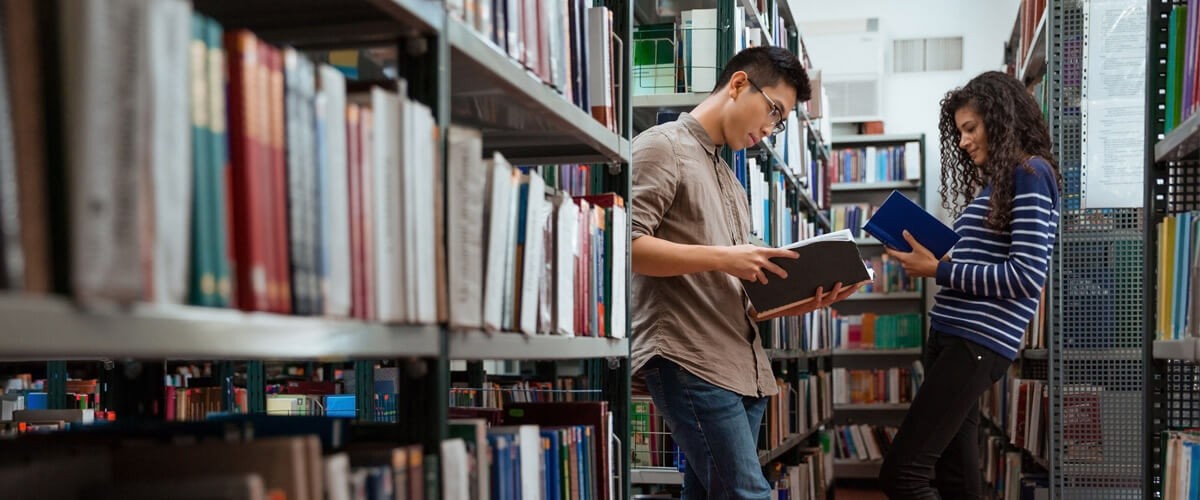 Students reading books in a library