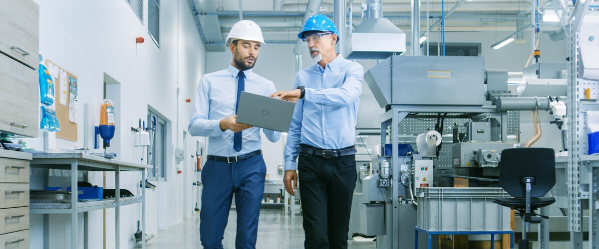 Business professionals walking in factory