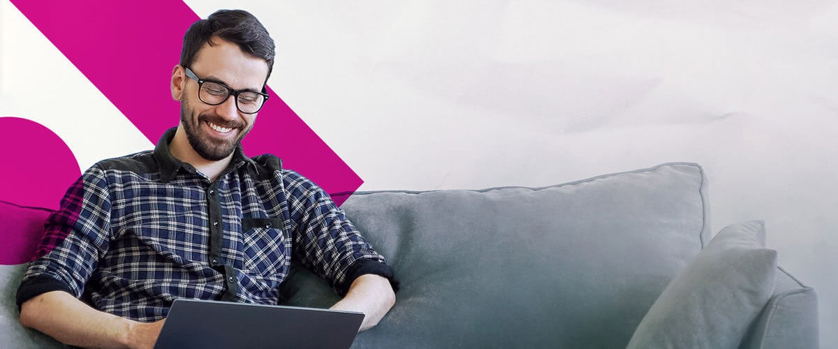 Guy smiling while using rented computer on couch. Cloud first, Rent A Center, Cloud strategy, Cloud technology, cloud business, modern business