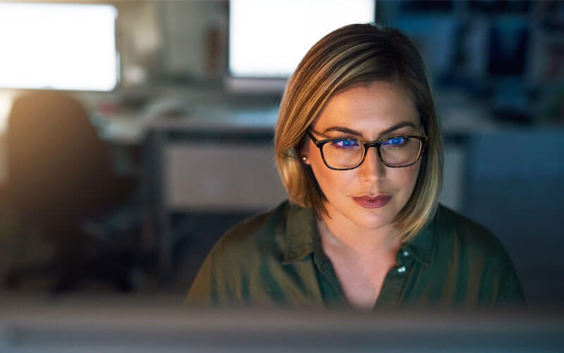 Woman smiling at monitor