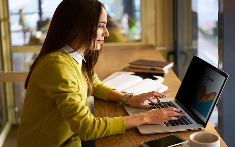 Woman on laptop using flip attached filter