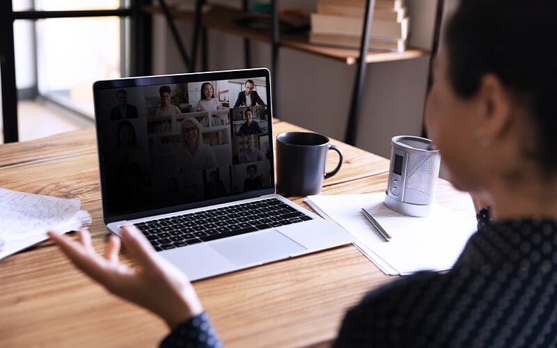 Woman on laptop device with black privacy filter