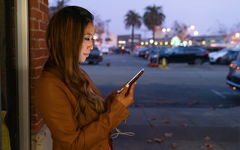 Woman using her phone outside