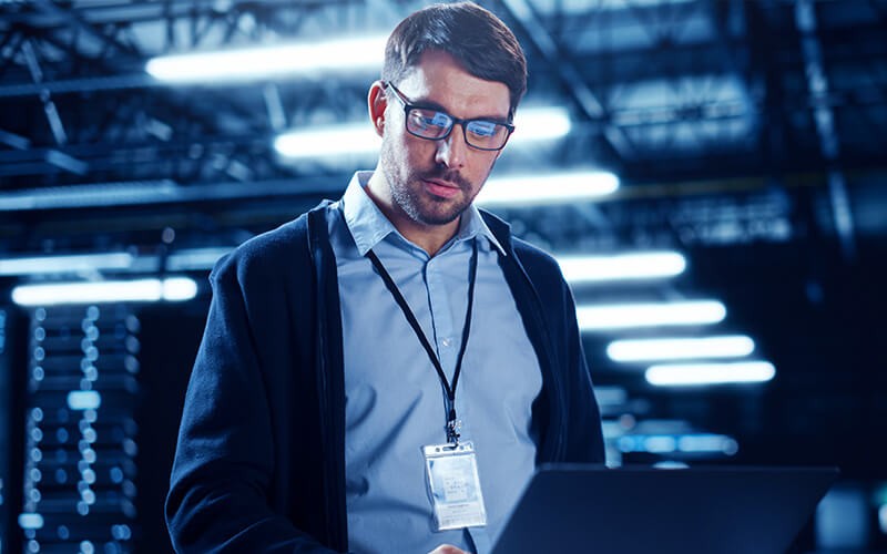 Man with glasses working using laptop