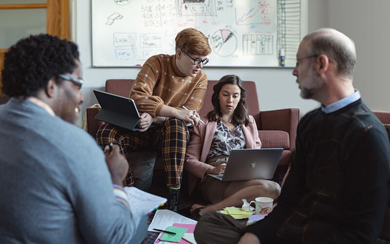 A team of Apple device users collaborating using Apple products