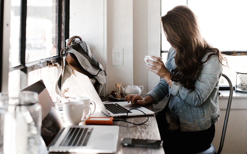 Woman working on laptop at coffee shop