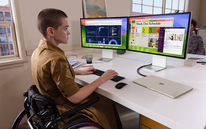 Woman working at desk with Apple MacBook M3 lifestyle