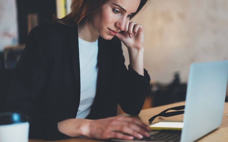 Woman looking at laptop device