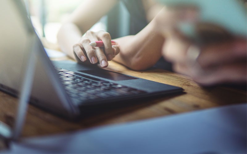 Woman hands typing on laptop