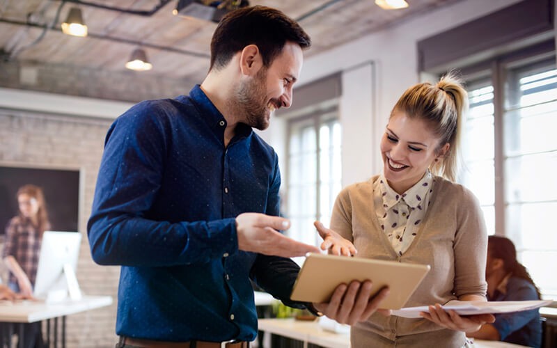 Two people collaborating in office