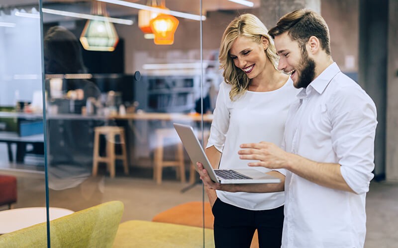 Professionals collaborating on a laptop