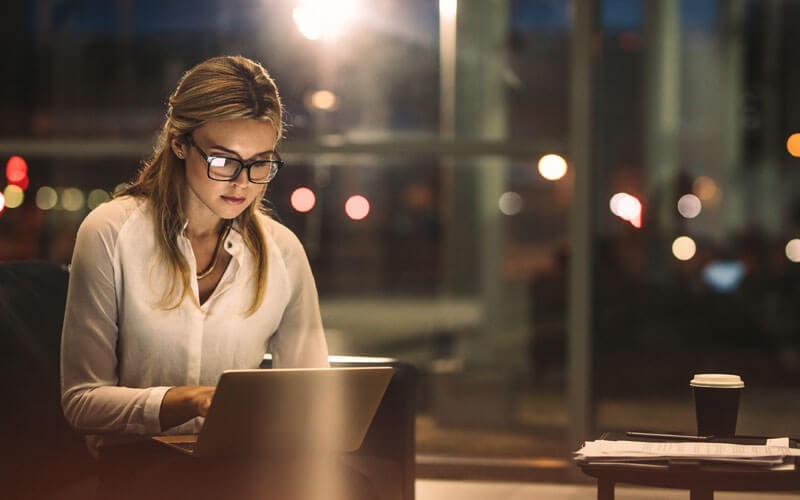 Woman using laptop out of office