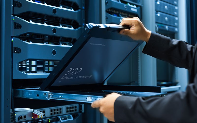 Dell employee in server room about to use laptop