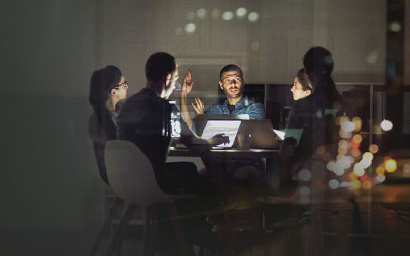 Team working around table late at night