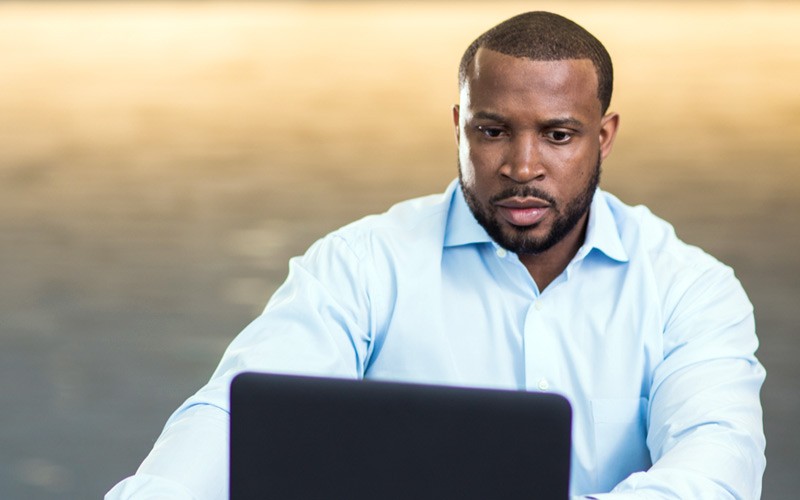 Business executive on notebook computer remotely