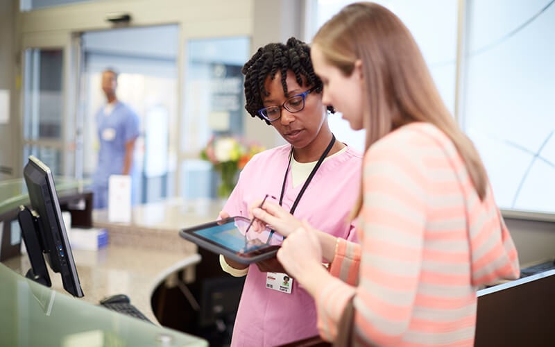 Nurse with patient using HP healthcare tablet device