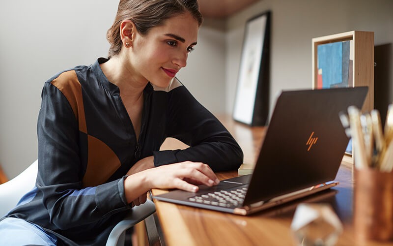 Business man holding HP convertible notebook