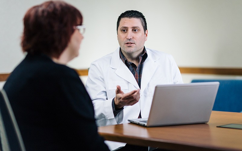 Doctor discussing health management with patient in home on laptop computer powered by Intel