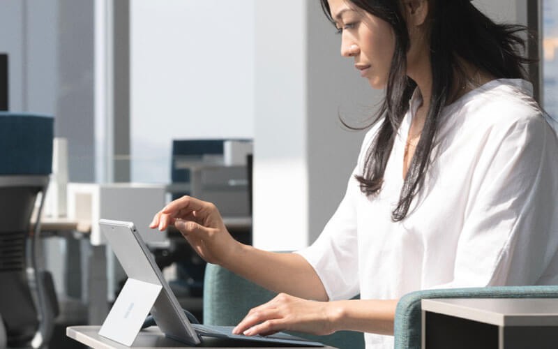 Woman working on Microsoft Surface device