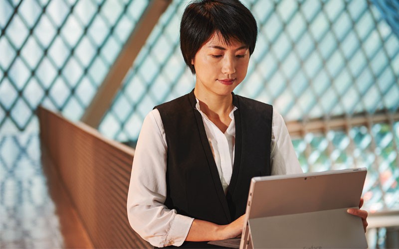 Woman working on Microsoft device