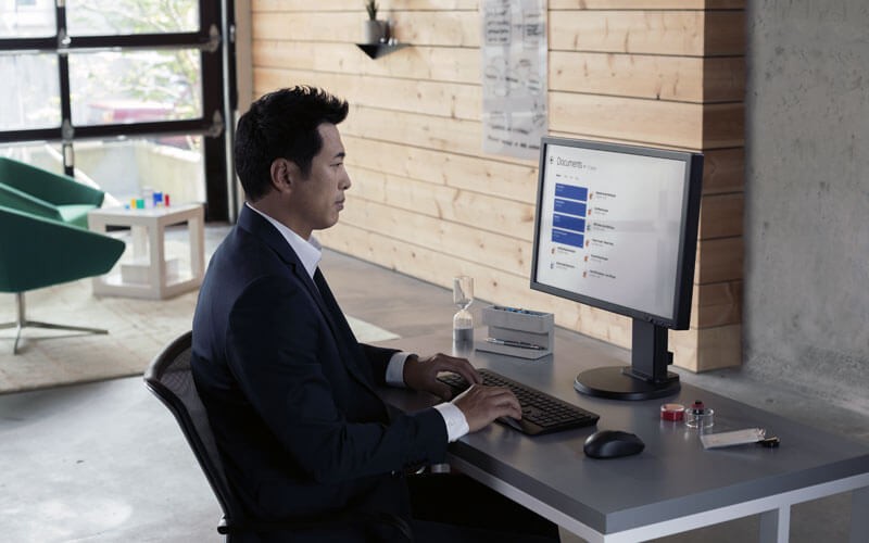 Businessman working on Microsoft computer