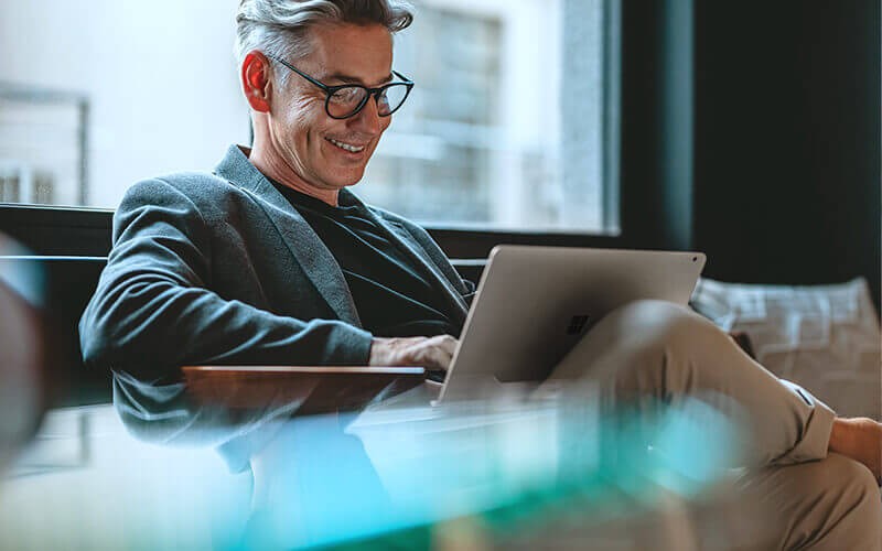 Man sitting while using his laptop