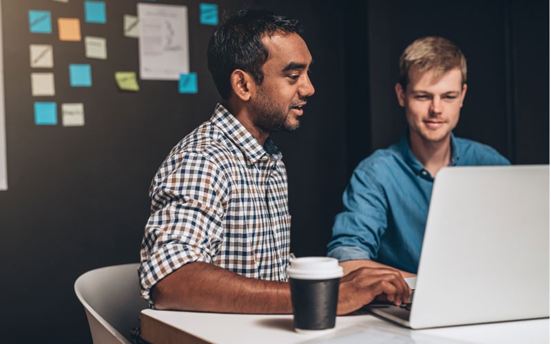 two-men-working-on-laptop