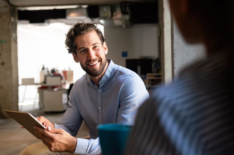 Smiling business professional using cloud computing capabilities from NetApp