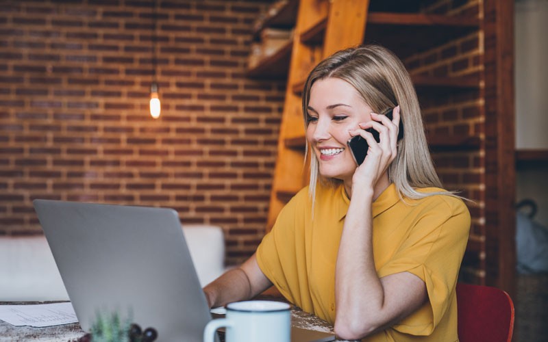 Woman on laptop and mobile device