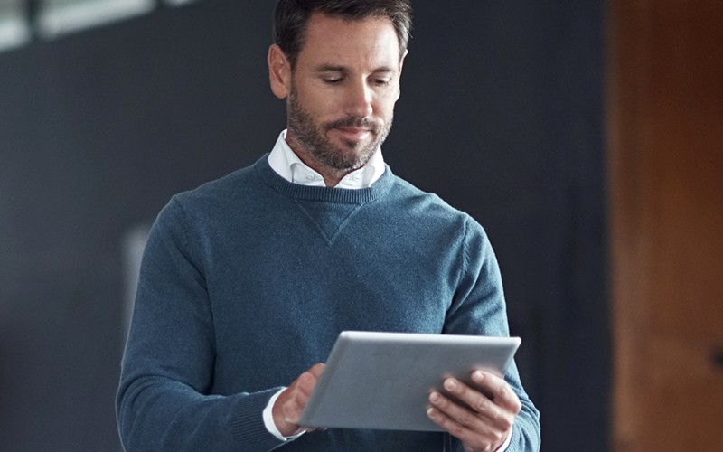 Man looking at tablet device