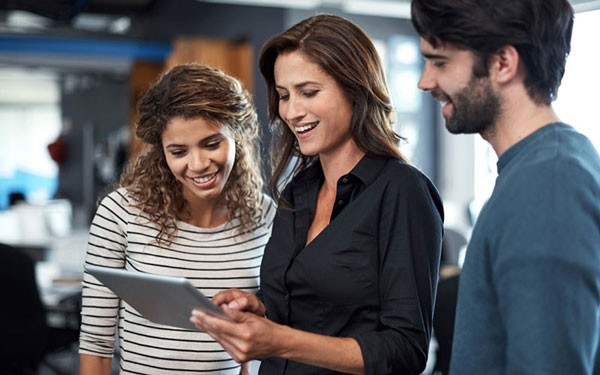 Three users smiling on tablet