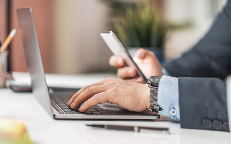 Man in suit using his laptop