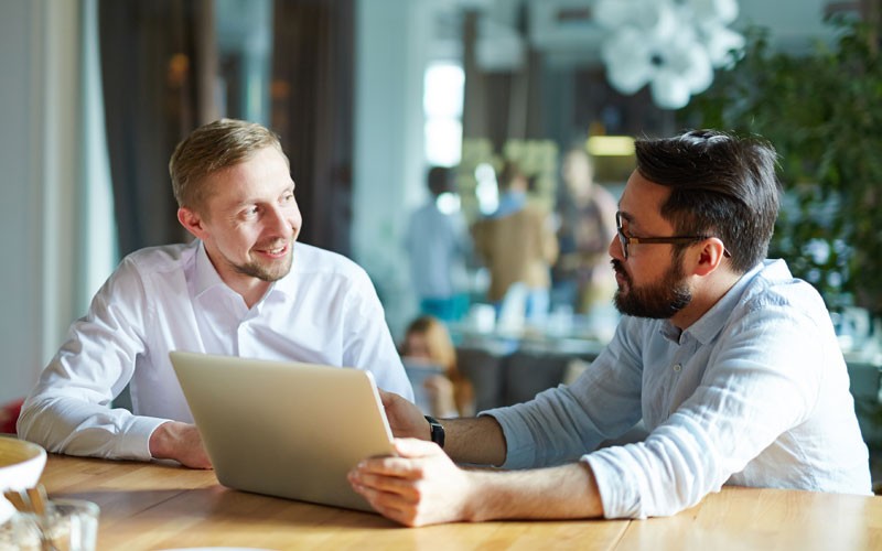 Two male workers having a discussion