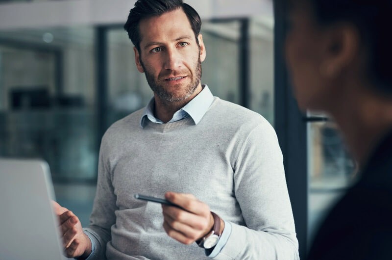 Businessman on laptop computer using application discovery tools