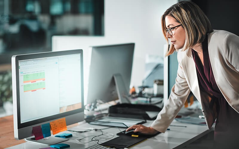 Businesswoman monitors data and security on computer