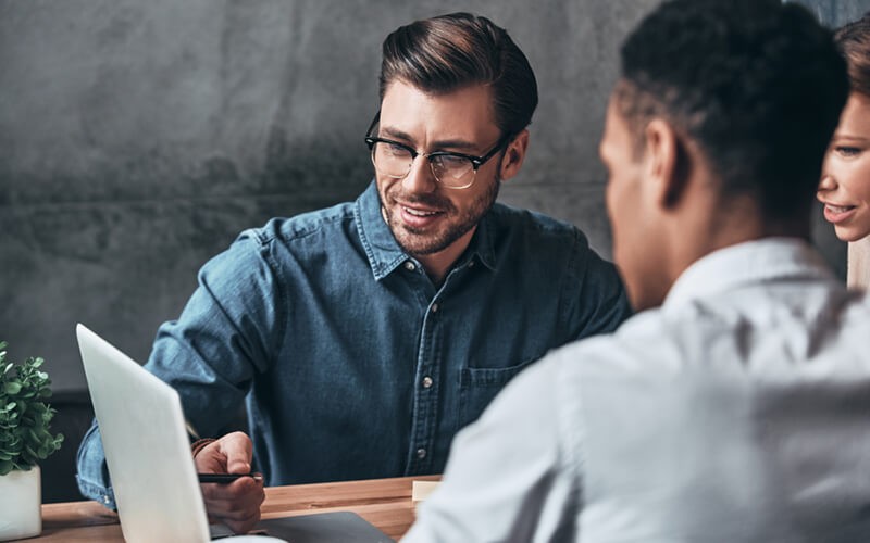 Businessman presents demo of software on computer